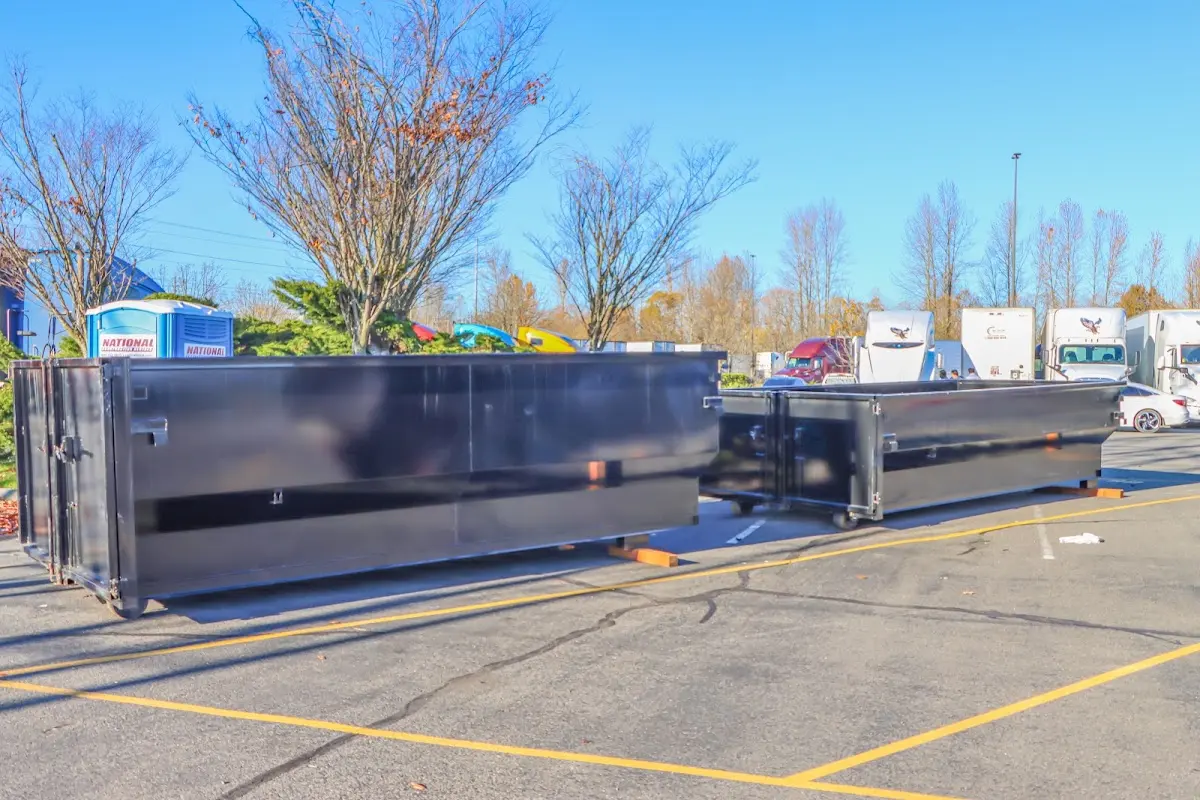Professional dumpster rental service with roll-off container on residential driveway in Midlothian
